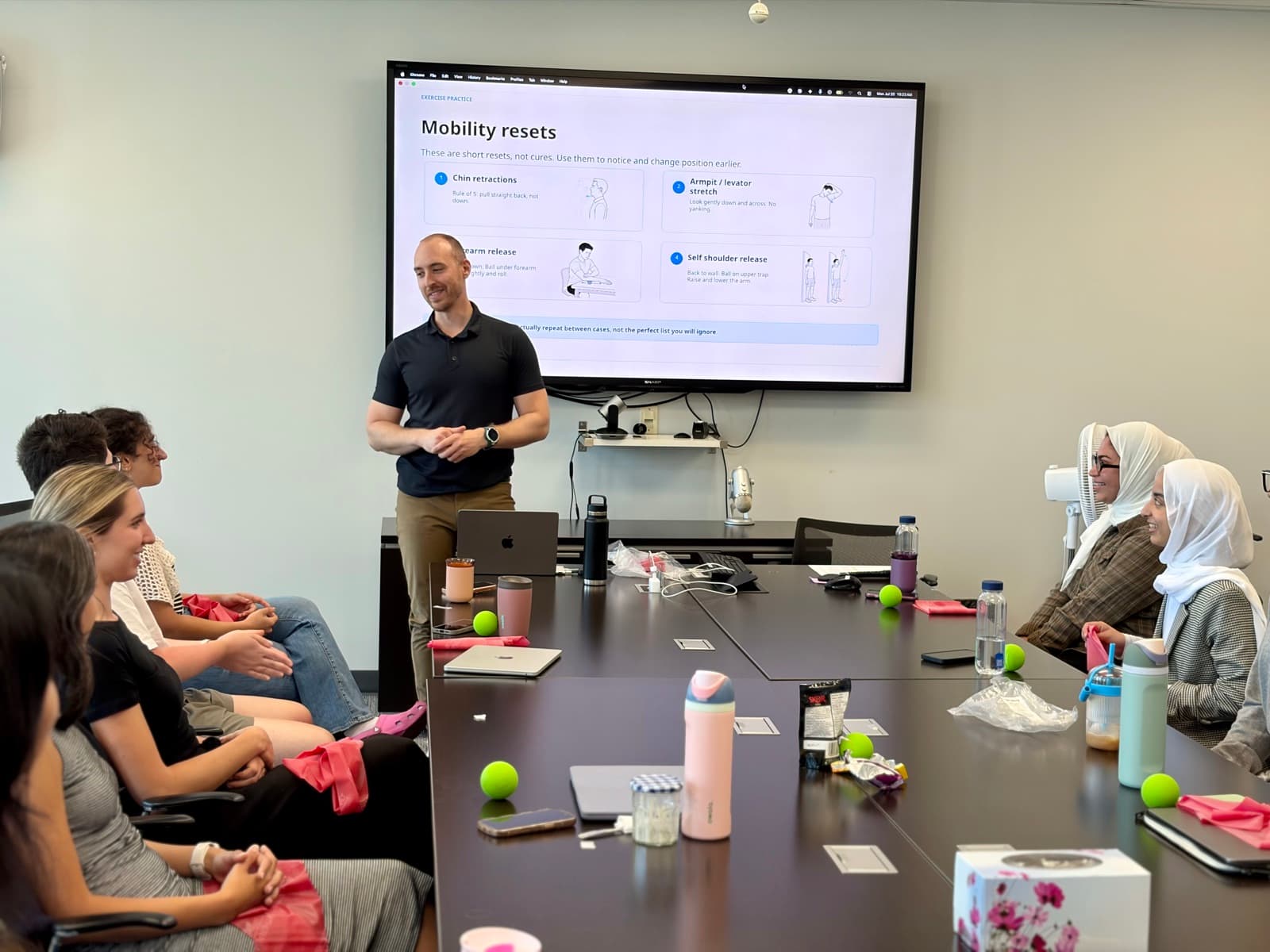 Mitchell Starkman teaching mobility resets during a corporate ergonomics workshop